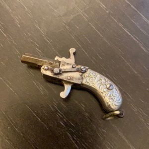 Little metal revolver pendant